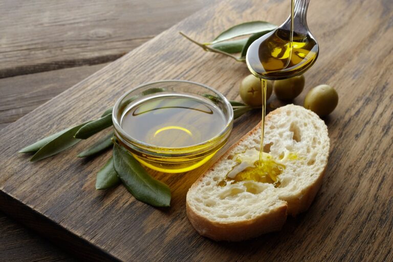 slice of bread seasoned with olive oil on wooden background